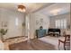 Spacious living room featuring wood floors and open view of the entryway, living space, and a piano at 10001 Regency Square Ave, Las Vegas, NV 89148