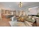Spacious living area featuring a large sofa, open layout and seamless flow to the kitchen at 10001 Regency Square Ave, Las Vegas, NV 89148