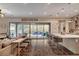 Open-concept living space with kitchen, dining area, and sliding doors to the outdoor patio at 10001 Regency Square Ave, Las Vegas, NV 89148