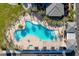 A stunning aerial view of the community pool, lined with palm trees and resort-style seating at 10001 Regency Square Ave, Las Vegas, NV 89148