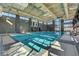 Bright indoor pool with lane dividers, surrounded by large windows and modern architectural details at 10001 Regency Square Ave, Las Vegas, NV 89148