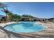 Large outdoor pool with lounge chairs, umbrellas, and tables, set against a scenic mountain backdrop at 10001 Regency Square Ave, Las Vegas, NV 89148