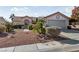 Charming single-story home featuring a tile roof, gravel yard, and well-maintained landscaping at 10033 Cresent Creek Dr, Las Vegas, NV 89134