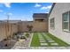This backyard has artificial turf, desert landscaping, and a brick perimeter fence at 10197 Copper Meadow Ave, Las Vegas, NV 89166