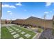 An outdoor backyard with pavers, artificial turf, desert landscaping, and a brick perimeter fence at 10197 Copper Meadow Ave, Las Vegas, NV 89166