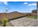 Backyard featuring a covered patio, artificial turf, desert landscaping, and perimeter fence at 10197 Copper Meadow Ave, Las Vegas, NV 89166