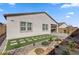 Landscaped backyard features artificial turf, stone pavers, and desert landscaping at 10197 Copper Meadow Ave, Las Vegas, NV 89166