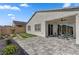 An outdoor backyard featuring desert landscaping, pavers, artificial turf, and a patio at 10197 Copper Meadow Ave, Las Vegas, NV 89166