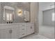 Chic bathroom featuring dual sinks, quartz countertops, and stylish wall sconces at 10197 Copper Meadow Ave, Las Vegas, NV 89166