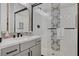 Bathroom features a glass enclosed shower with black hardware, unique tile accent and modern vanity at 10197 Copper Meadow Ave, Las Vegas, NV 89166
