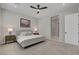 Neutral bedroom features a plush bed, ceiling fan, and artwork that add a touch of elegance to the space at 10197 Copper Meadow Ave, Las Vegas, NV 89166