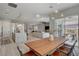 Open-concept dining area showcasing a wooden table and bench seating, connecting to the kitchen at 10197 Copper Meadow Ave, Las Vegas, NV 89166