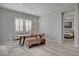 Modern dining area with light wood floors, stylish chandelier, and plantation shutters at 10197 Copper Meadow Ave, Las Vegas, NV 89166