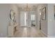 Inviting entryway featuring light wood floors, a stylish console table, and modern chandelier at 10197 Copper Meadow Ave, Las Vegas, NV 89166