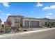 Home featuring a three-car garage, desert landscaping, and a neutral color scheme at 10197 Copper Meadow Ave, Las Vegas, NV 89166