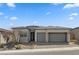 Charming single-story home with a three-car garage, stone accents, and a beautifully landscaped front yard at 10197 Copper Meadow Ave, Las Vegas, NV 89166