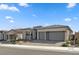 Charming home exterior with a three-car garage, desert landscaping and neutral colors at 10197 Copper Meadow Ave, Las Vegas, NV 89166