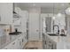 Modern kitchen featuring a stainless steel refrigerator, white cabinets, and an island with bar seating at 10197 Copper Meadow Ave, Las Vegas, NV 89166