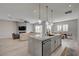 Open-concept kitchen and living area with stylish pendant lighting over the kitchen island at 10197 Copper Meadow Ave, Las Vegas, NV 89166