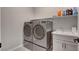 Functional laundry room with stacked washer and dryer, complemented by a sink and ample storage at 10197 Copper Meadow Ave, Las Vegas, NV 89166