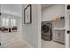 This functional laundry room has a washer and dryer and a sink with storage underneath at 10197 Copper Meadow Ave, Las Vegas, NV 89166
