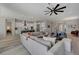 Open-concept living room featuring modern decor, a ceiling fan, and seamless flow to the kitchen at 10197 Copper Meadow Ave, Las Vegas, NV 89166