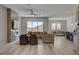 Bright open-concept living area featuring a fireplace, modern furniture and great natural light at 10197 Copper Meadow Ave, Las Vegas, NV 89166