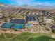Aerial view of the community featuring tennis courts, community pool, recreation center, and mountain views at 10508 Snyder Ave, Las Vegas, NV 89134