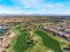 Breathtaking aerial view showcasing community, golf course, with stunning mountain range as background at 10508 Snyder Ave, Las Vegas, NV 89134