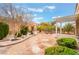 Well-manicured backyard with lush landscaping, a stone patio, and a covered pergola, perfect for outdoor living at 10508 Snyder Ave, Las Vegas, NV 89134