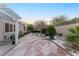 Well-maintained backyard with a stone patio, lush greenery, mature trees and beautiful landscaping at 10508 Snyder Ave, Las Vegas, NV 89134