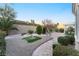 Expansive backyard featuring decorative stone, lush greenery, and privacy landscaping in a desert environment at 10508 Snyder Ave, Las Vegas, NV 89134