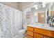 Bathroom with sink vanity, mirror, toilet, and shower with patterned curtain at 10508 Snyder Ave, Las Vegas, NV 89134