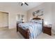 Comfortable bedroom with carpeted flooring, a ceiling fan, and a mirrored closet at 10508 Snyder Ave, Las Vegas, NV 89134