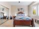 Comfortable bedroom with a wood bed frame, ceiling fan and mirrored closet at 10508 Snyder Ave, Las Vegas, NV 89134