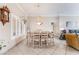 Open dining space featuring a modern chandelier, plantation shutters, and convenient access to the living area at 10508 Snyder Ave, Las Vegas, NV 89134