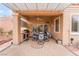 Covered patio area with outdoor table and chairs and built in BBQ grill at 10508 Snyder Ave, Las Vegas, NV 89134