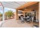 Outdoor patio area with pergola, dining table, seating, and built-in grill, ideal for entertaining at 10508 Snyder Ave, Las Vegas, NV 89134