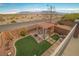 Backyard with covered patio and small grass section, perfect for relaxation and enjoyment at 10548 Nantucket Ridge Ave, Las Vegas, NV 89166