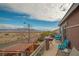 Relaxing balcony with comfortable chairs, a grill, and views of the surrounding landscape and mountains at 10548 Nantucket Ridge Ave, Las Vegas, NV 89166