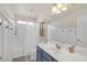 Bright bathroom with shower and tub combination, white cabinets and neutral colors for a clean feel at 10548 Nantucket Ridge Ave, Las Vegas, NV 89166