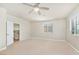 Neutral bedroom with a ceiling fan, carpeted floors, and view into the stairwell at 10548 Nantucket Ridge Ave, Las Vegas, NV 89166