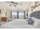 Bright bedroom with a large window overlooking an outdoor view, complemented by neutral tones and soft decor at 10548 Nantucket Ridge Ave, Las Vegas, NV 89166