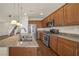 Well-lit kitchen with wood cabinets, stainless steel appliances, granite countertops, and a dual sink island at 10548 Nantucket Ridge Ave, Las Vegas, NV 89166
