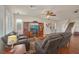 Spacious living room with hardwood floors, a ceiling fan, and a staircase leading to the upper level at 10548 Nantucket Ridge Ave, Las Vegas, NV 89166