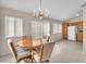 Bright dining room with chandelier, sliding glass door, and tile flooring at 1163 Teal Point Dr, Henderson, NV 89074