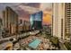 Enjoy resort-style living with a pristine pool, palm trees, and stunning city views at sunset at 135 E Harmon Ave # 1919, Las Vegas, NV 89109