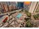 Luxury resort pool featuring lounge chairs, umbrellas, palm trees, and city views at 135 E Harmon Ave # 1919, Las Vegas, NV 89109