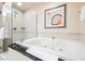 This elegant bathroom features a luxurious bathtub, a glass-enclosed shower, and modern fixtures at 135 E Harmon Ave # 1919, Las Vegas, NV 89109
