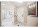 Inviting hallway featuring black and white tile, opening to a bathroom with a tub at 135 E Harmon Ave # 1919, Las Vegas, NV 89109
